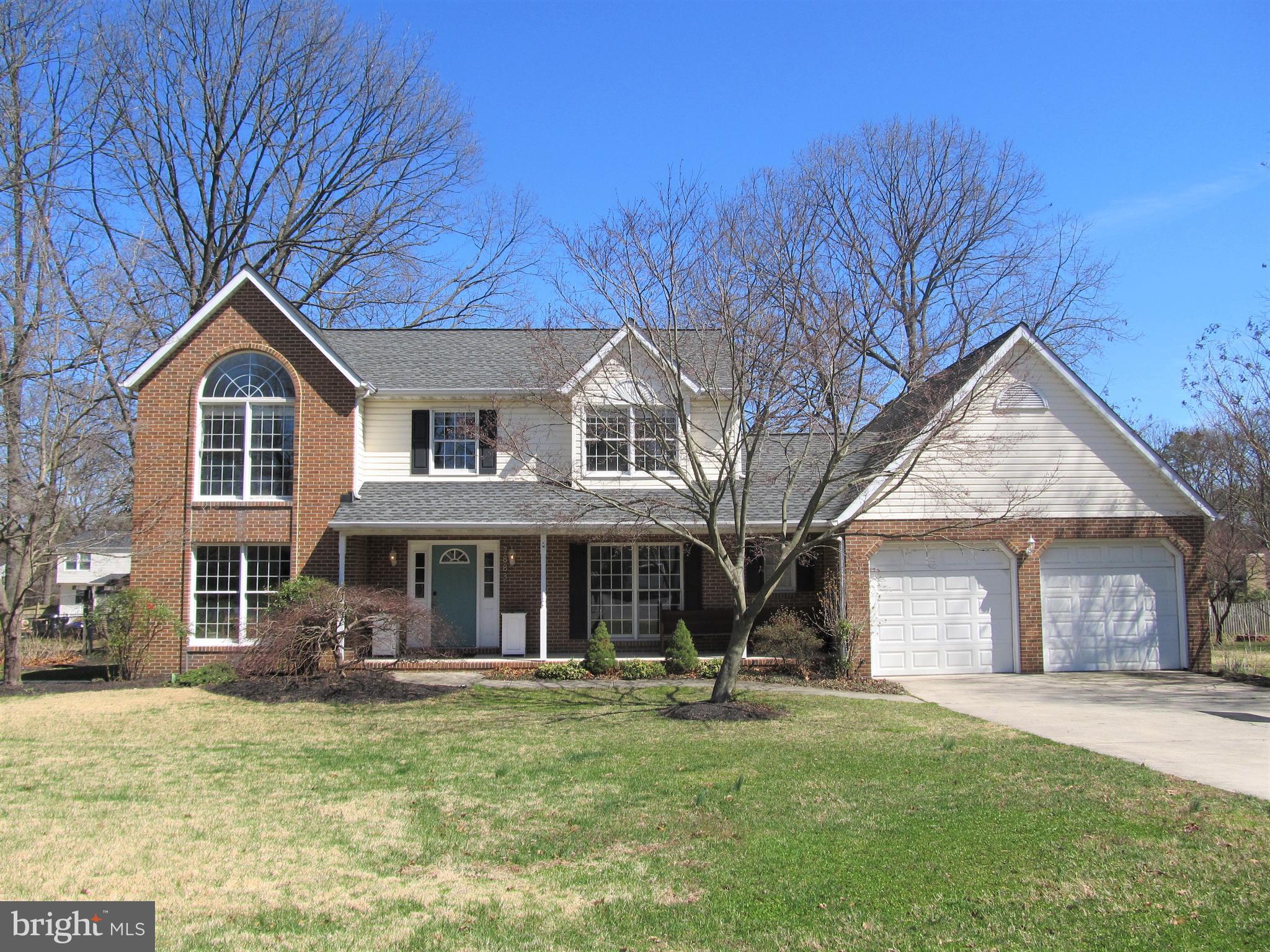 7883 Poplar Grove Road Severn, MD 21144 - Photo 73 of 77 a front view of a house with a yard and trees