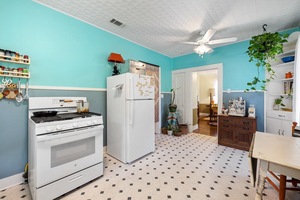807 Cecelia Street Taylor, TX 76574 - Photo 10 of 24 a kitchen with a refrigerator and a stove