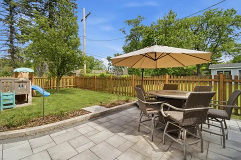 a patio with a yard table and chairs