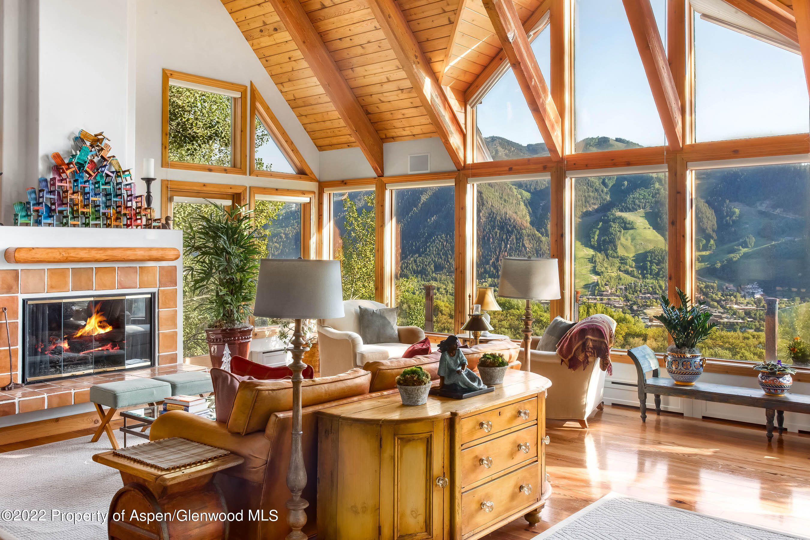 346 East Reds Road Aspen, CO 81612 - Photo 5 of 41 a living room with fireplace furniture and a floor to ceiling window