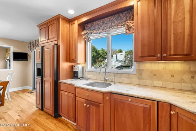 a kitchen with stainless steel appliances granite countertop a refrigerator and a sink