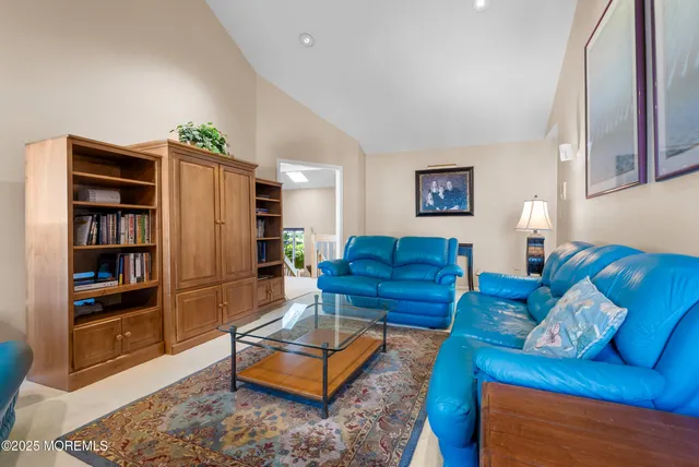 a living room with furniture and a book shelf