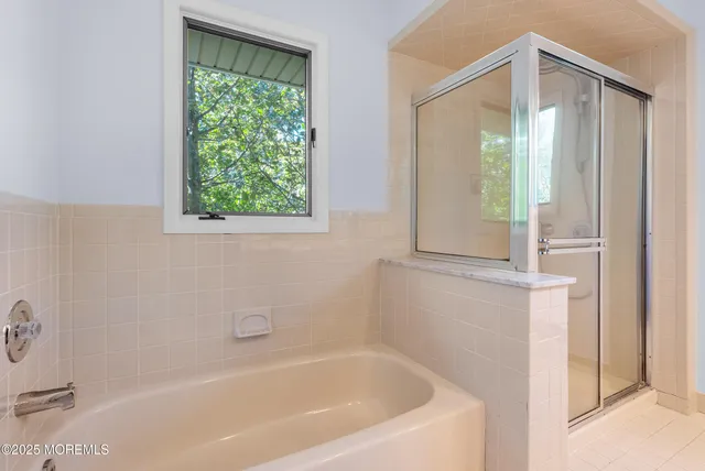 a bathroom with a bathtub and shower