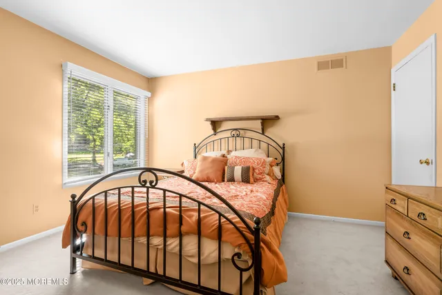 a view of a bedroom with furniture and windows