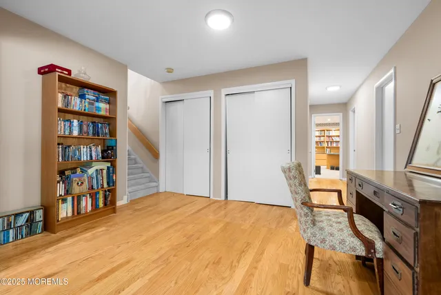 a bedroom with furniture and a book shelf