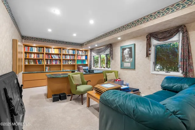 a living room with furniture and a floor to ceiling window