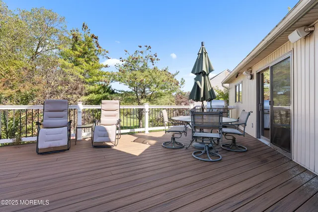 a view of a deck with table and chairs and wooden floor
