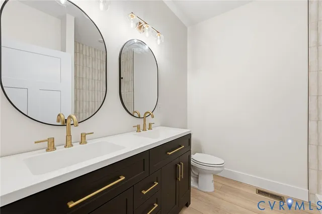 a bathroom with a toilet a sink and a mirror