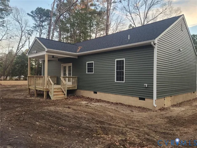 a view of a chair and table in backyard of the house