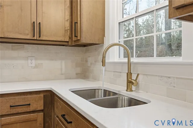 a kitchen with a sink and cabinets