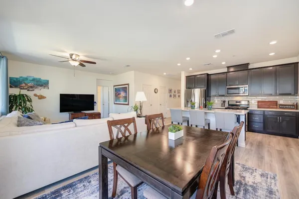 a view of a dining room with furniture and wooden floor