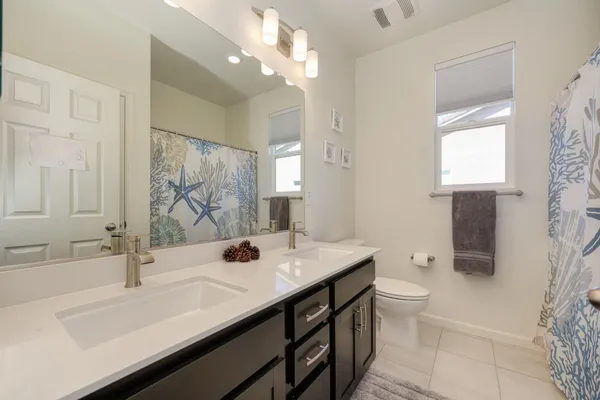 a bathroom with a sink double vanity and a mirror