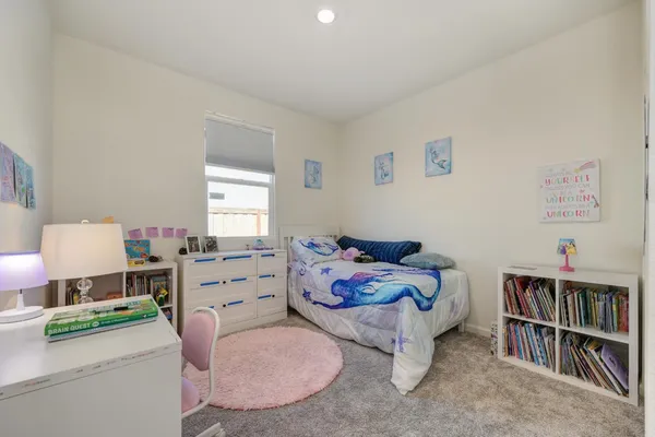a bedroom with a bed and a book shelf