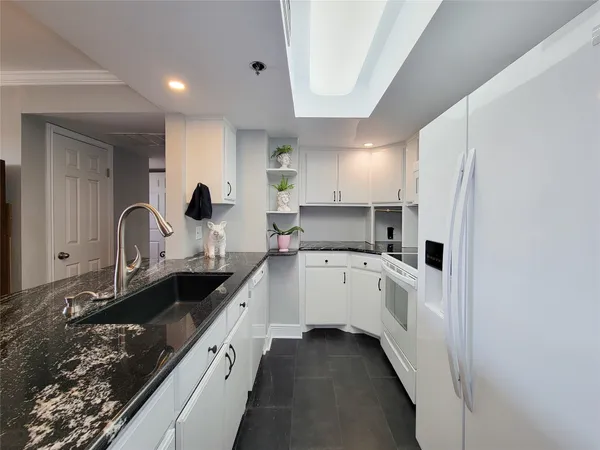 a large kitchen with a sink and cabinets