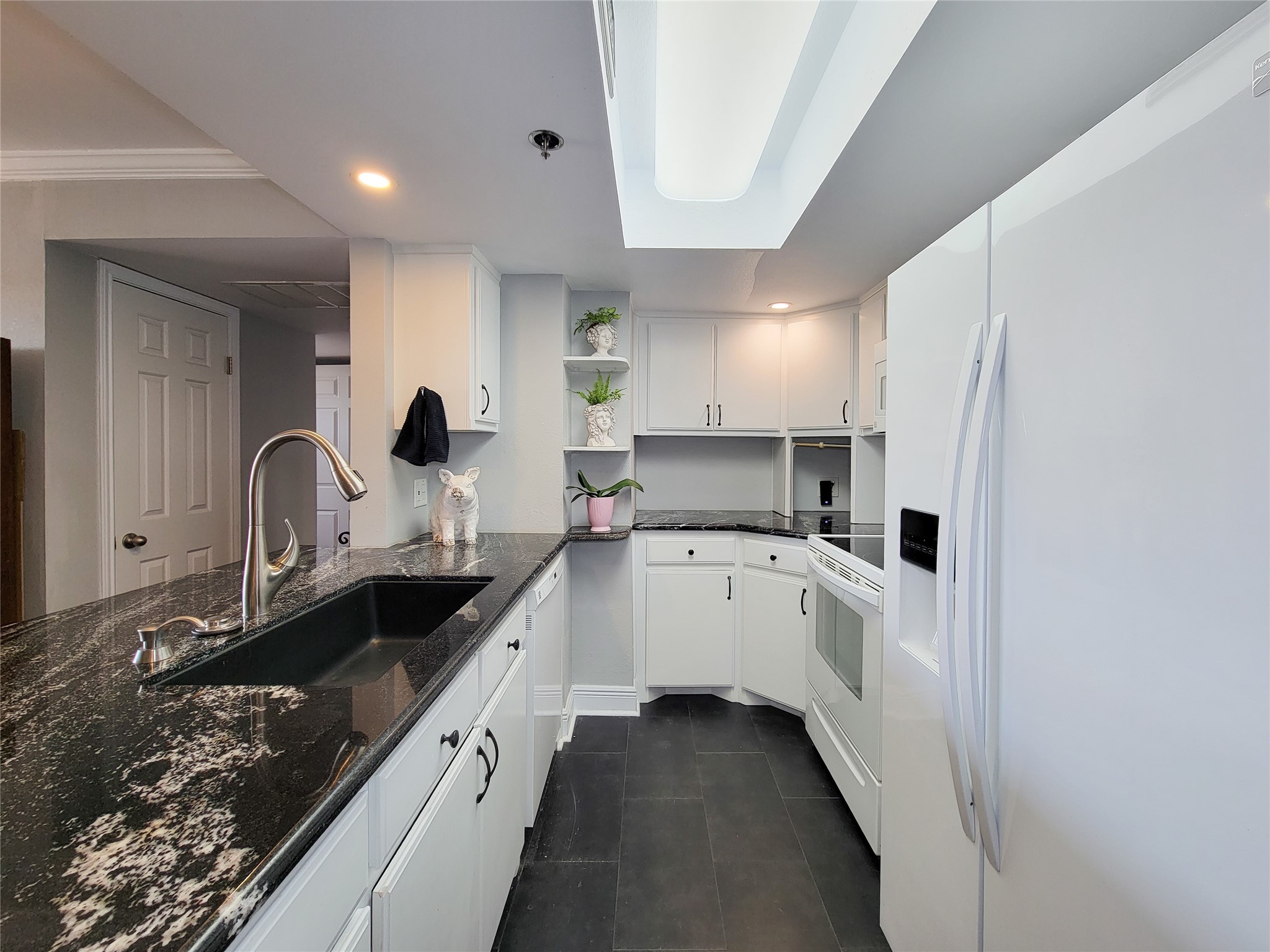 a large kitchen with a sink and cabinets