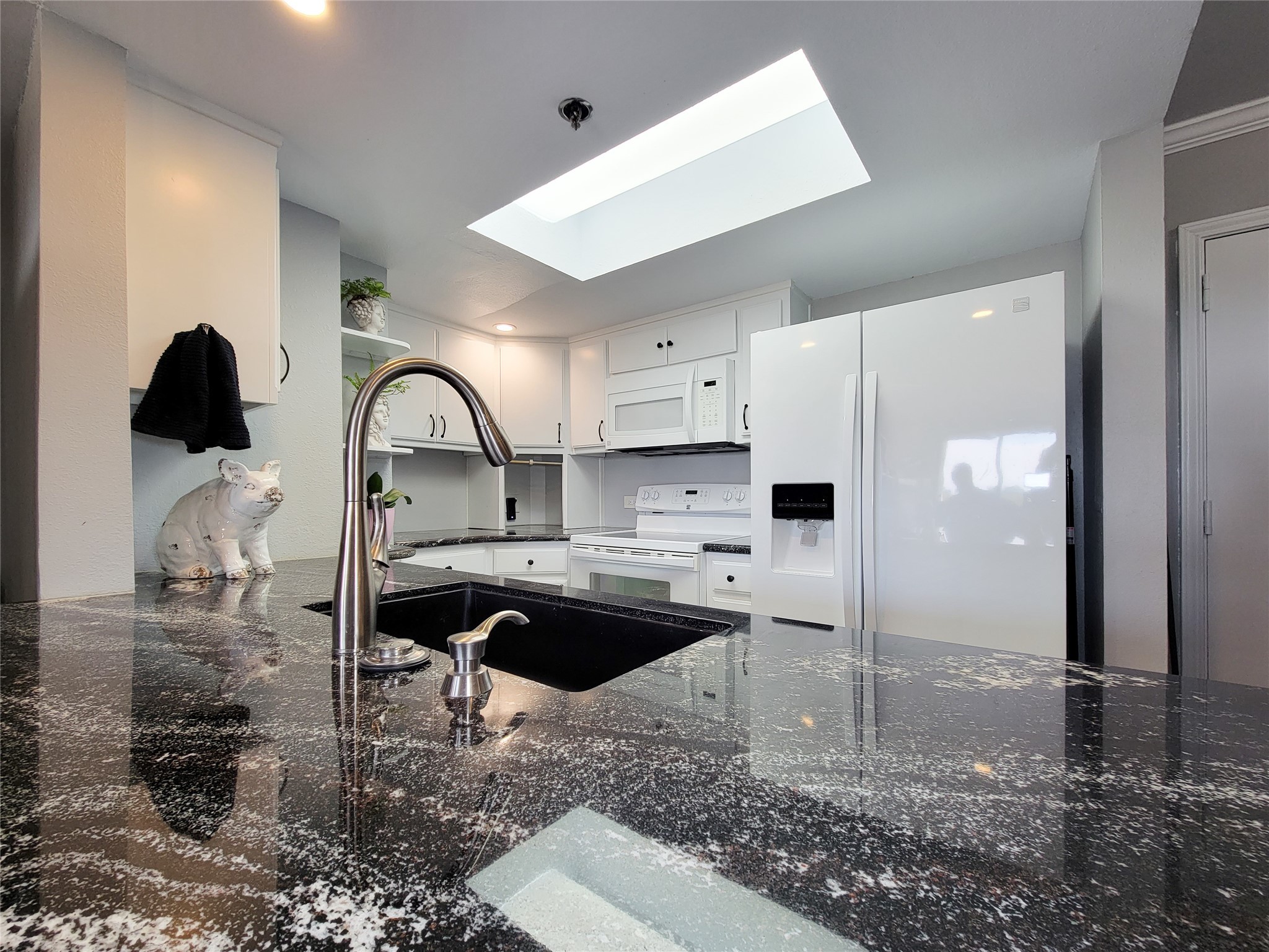 3525 Sage Road, Unit 402 Houston, TX 77056 - Photo 2 of 39 a kitchen with stainless steel appliances kitchen island granite countertop a refrigerator and a sink