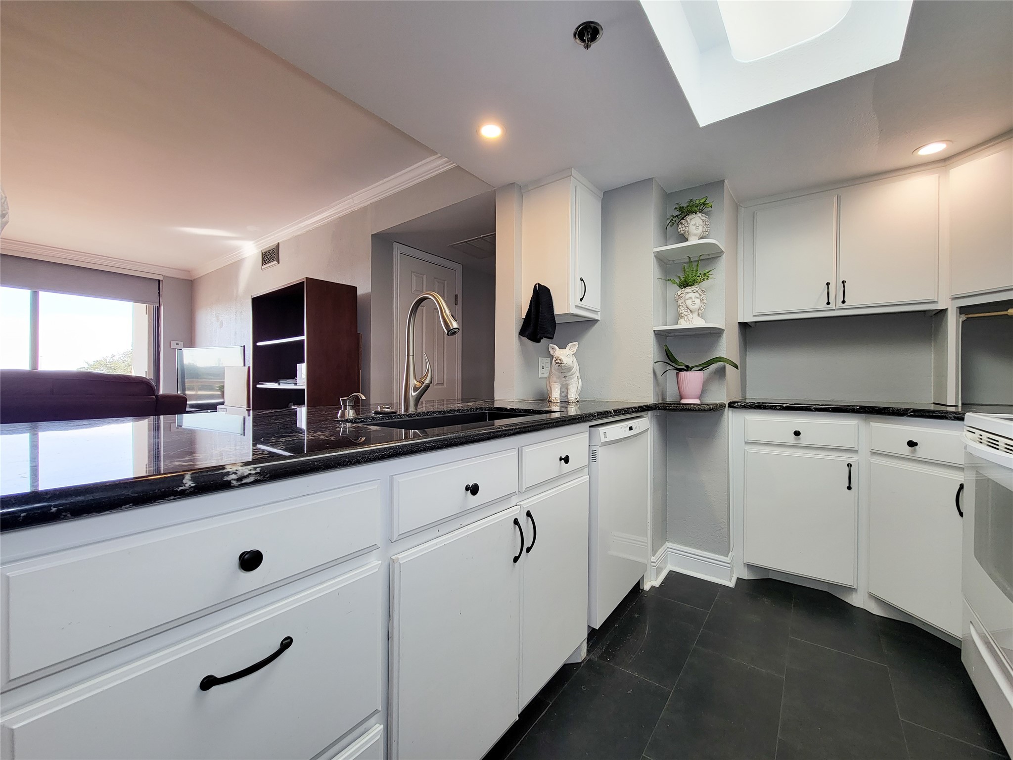 3525 Sage Road, Unit 402 Houston, TX 77056 - Photo 3 of 39 a kitchen with granite countertop white cabinets and white appliances