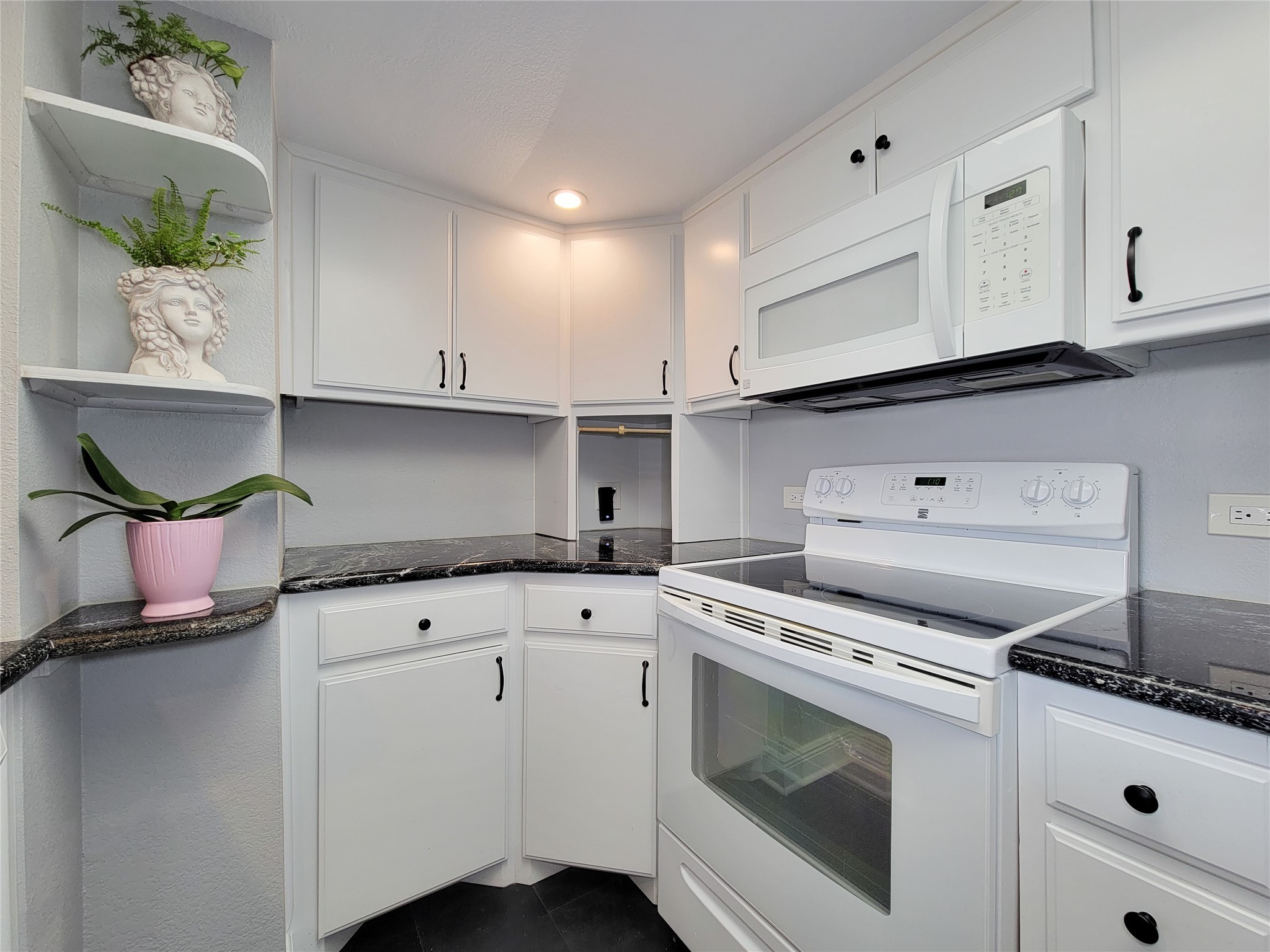 3525 Sage Road, Unit 402 Houston, TX 77056 - Photo 4 of 39 a kitchen with granite countertop white cabinets and white appliances