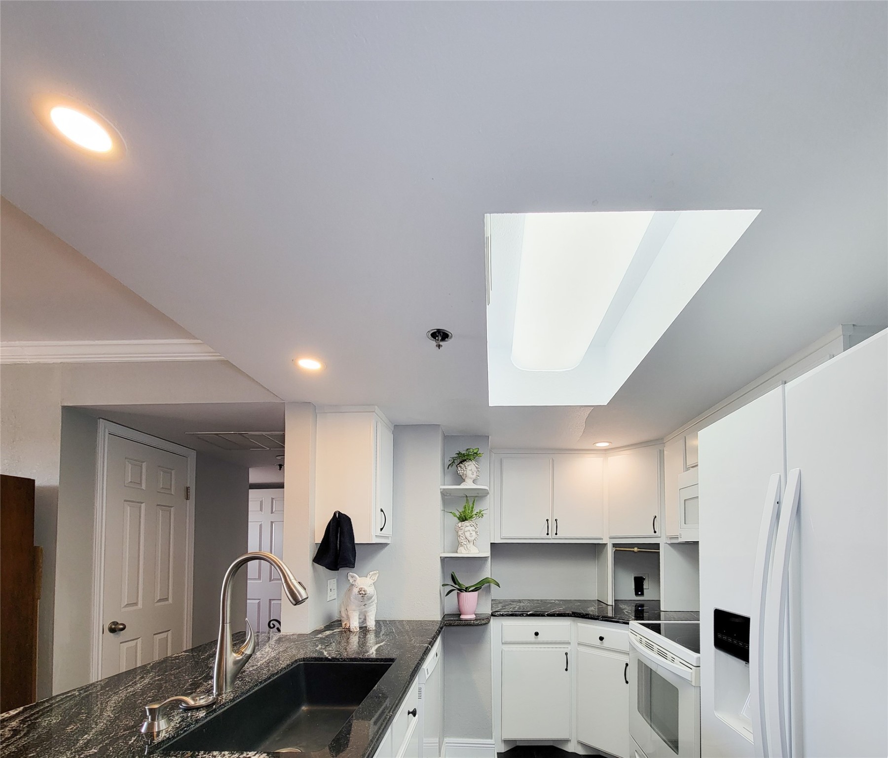 3525 Sage Road, Unit 402 Houston, TX 77056 - Photo 6 of 39 a kitchen with a sink a refrigerator and cabinets