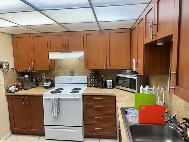 a kitchen with refrigerator and cabinets