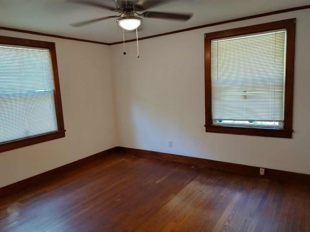 116 County Road Southampton, MA 01073 - Photo 15 of 18 an empty room with wooden floor fan and windows