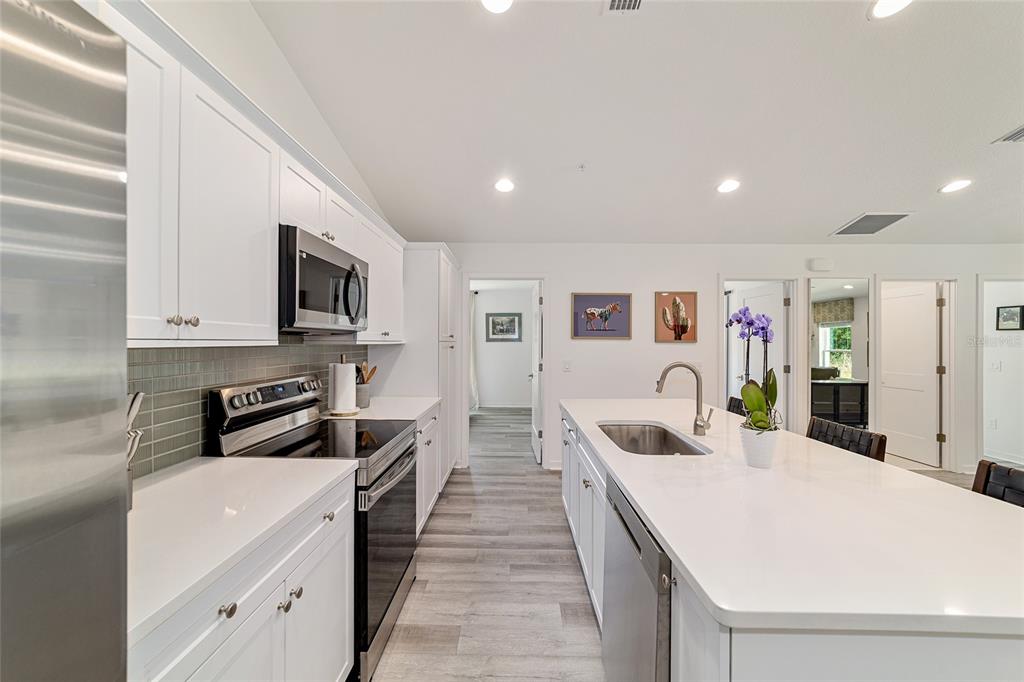 4400 Northwest 74th Terrace Ocala, FL 34482 - Photo 14 of 39 a large white kitchen with stainless steel appliances