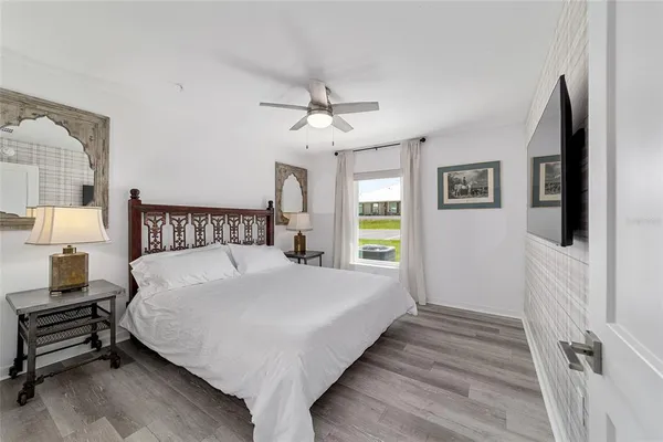 a bedroom with a bed and a chandelier