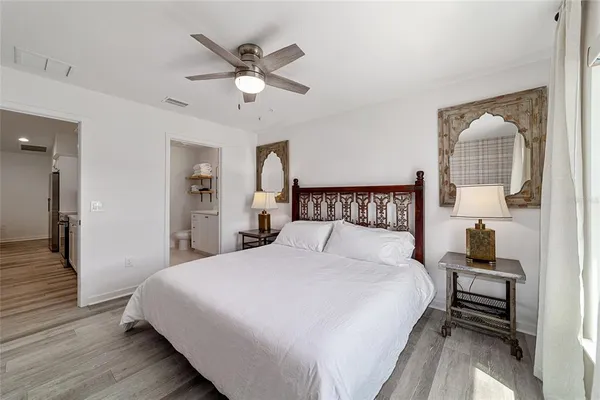 a bedroom with a bed and a chandelier