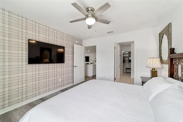 a bedroom with a bed and a flat screen tv