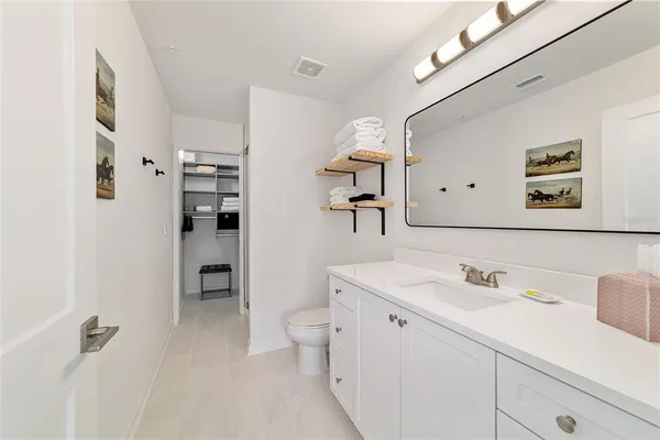 a spacious bathroom with a toilet sink and shower