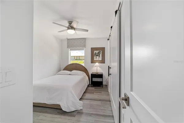 a bed room with a bed and a chandelier