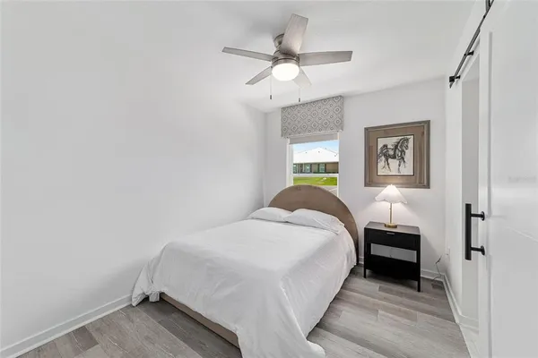 a bedroom with a bed and a chandelier
