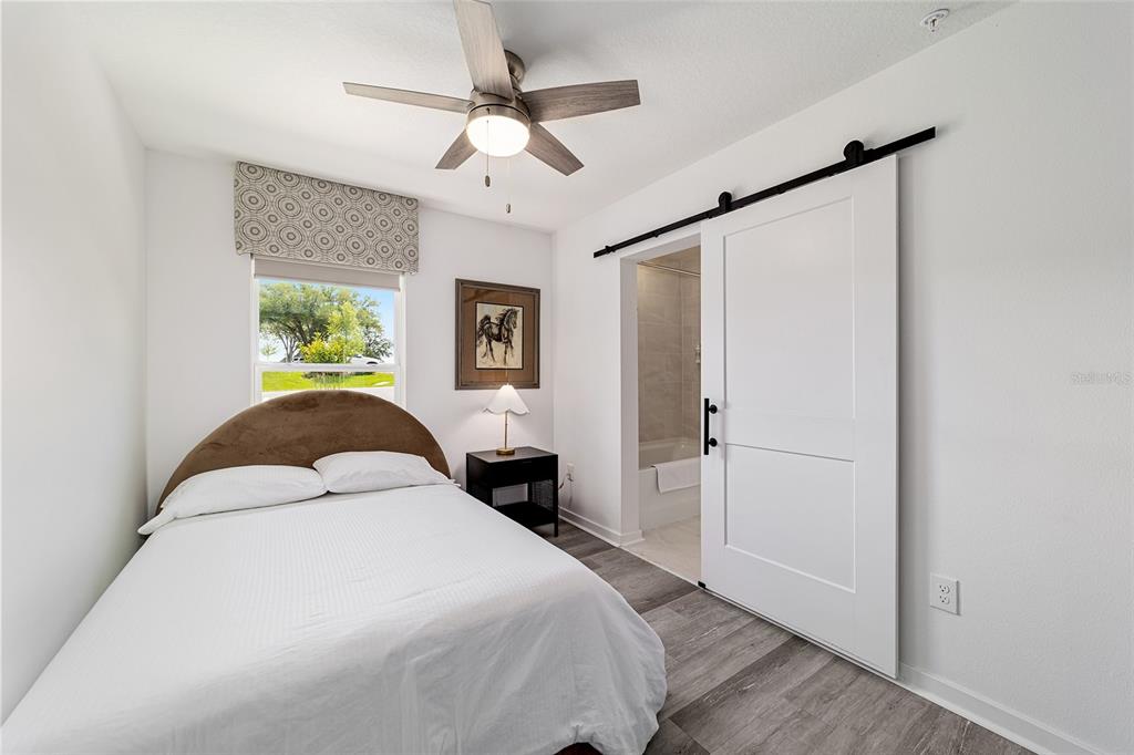 4400 Northwest 74th Terrace Ocala, FL 34482 - Photo 28 of 39 a spacious bedroom with a bed and a chandelier