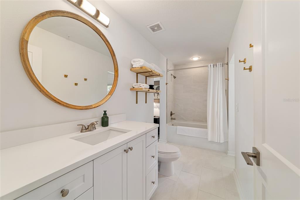 4400 Northwest 74th Terrace Ocala, FL 34482 - Photo 29 of 39 a bathroom with a sink a toilet and a mirror