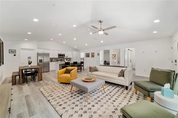 a living room with furniture and kitchen view