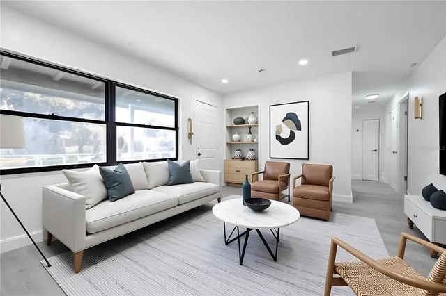 a living room with furniture and a large window