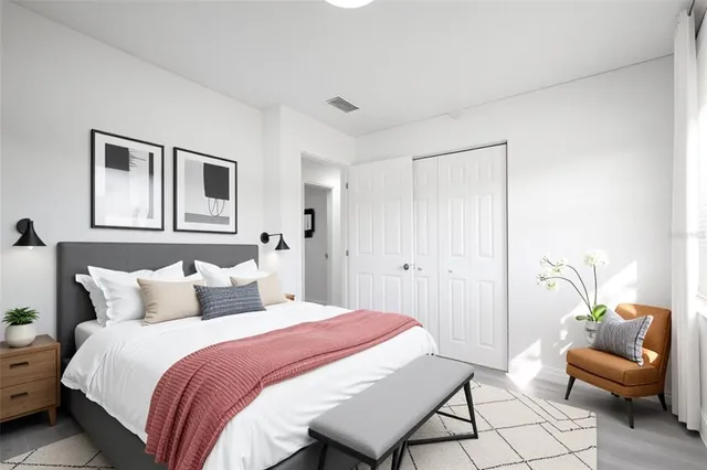 a bedroom with a bed and a couch