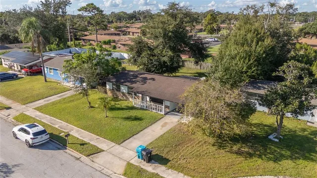 an aerial view of a house with yard swimming pool and outdoor seating