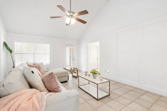 a living room with furniture a fireplace and a chandelier