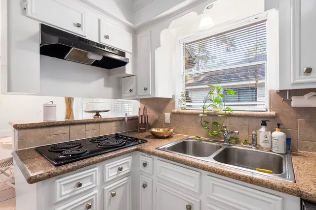 a kitchen with a refrigerator stove and sink