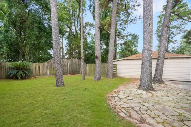 a front view of a house with a tree in a yard