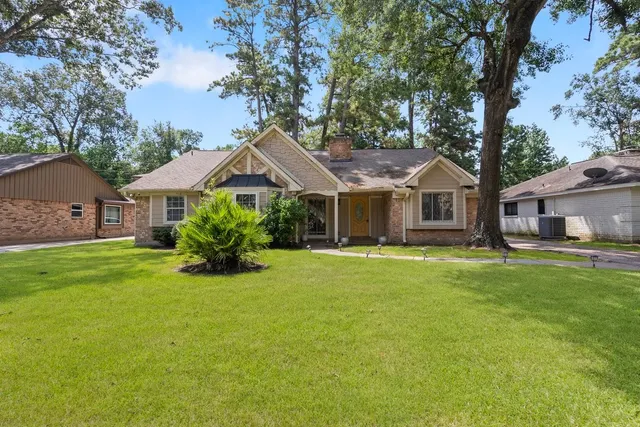 a view of backyard with outdoor seating and trees