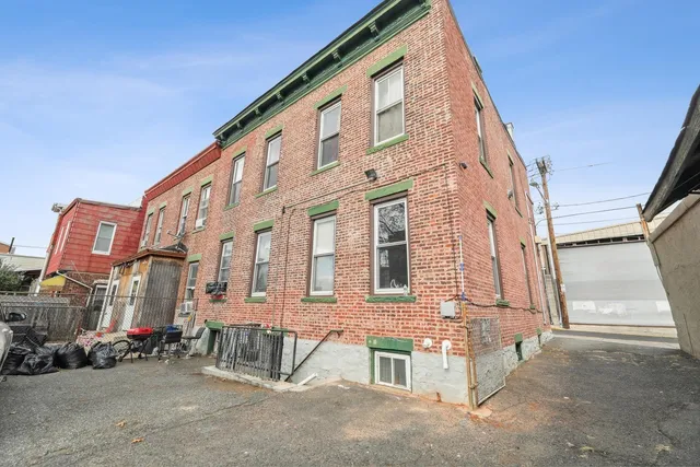 a view of a brick building with many windows