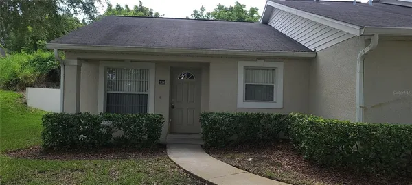 a view of a house with potted plants