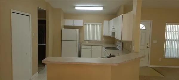 a kitchen with a sink and refrigerator