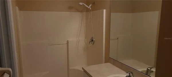 a bathroom with a shower and a sink