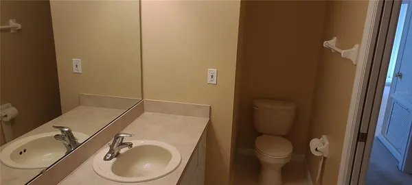 a bathroom with a sink toilet and mirror