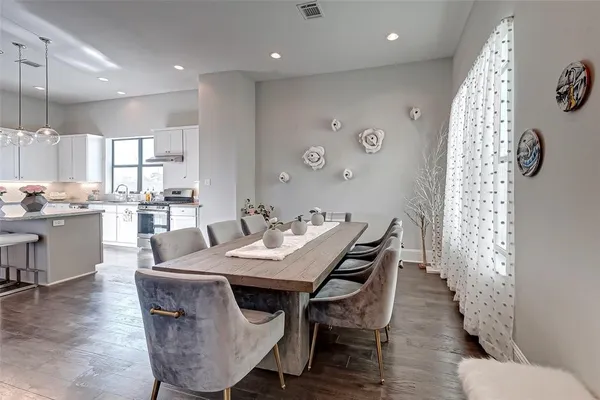 a dinning room with furniture kitchen view and a flat screen tv
