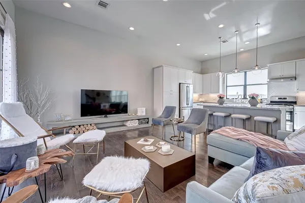 a living room with furniture and kitchen view