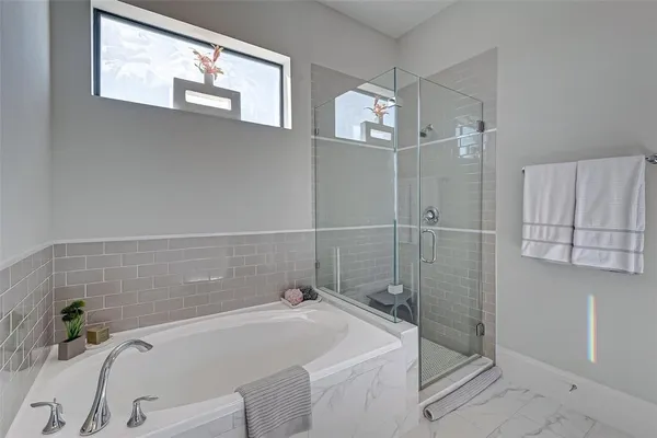 a bedroom with a bed and painting on the wall